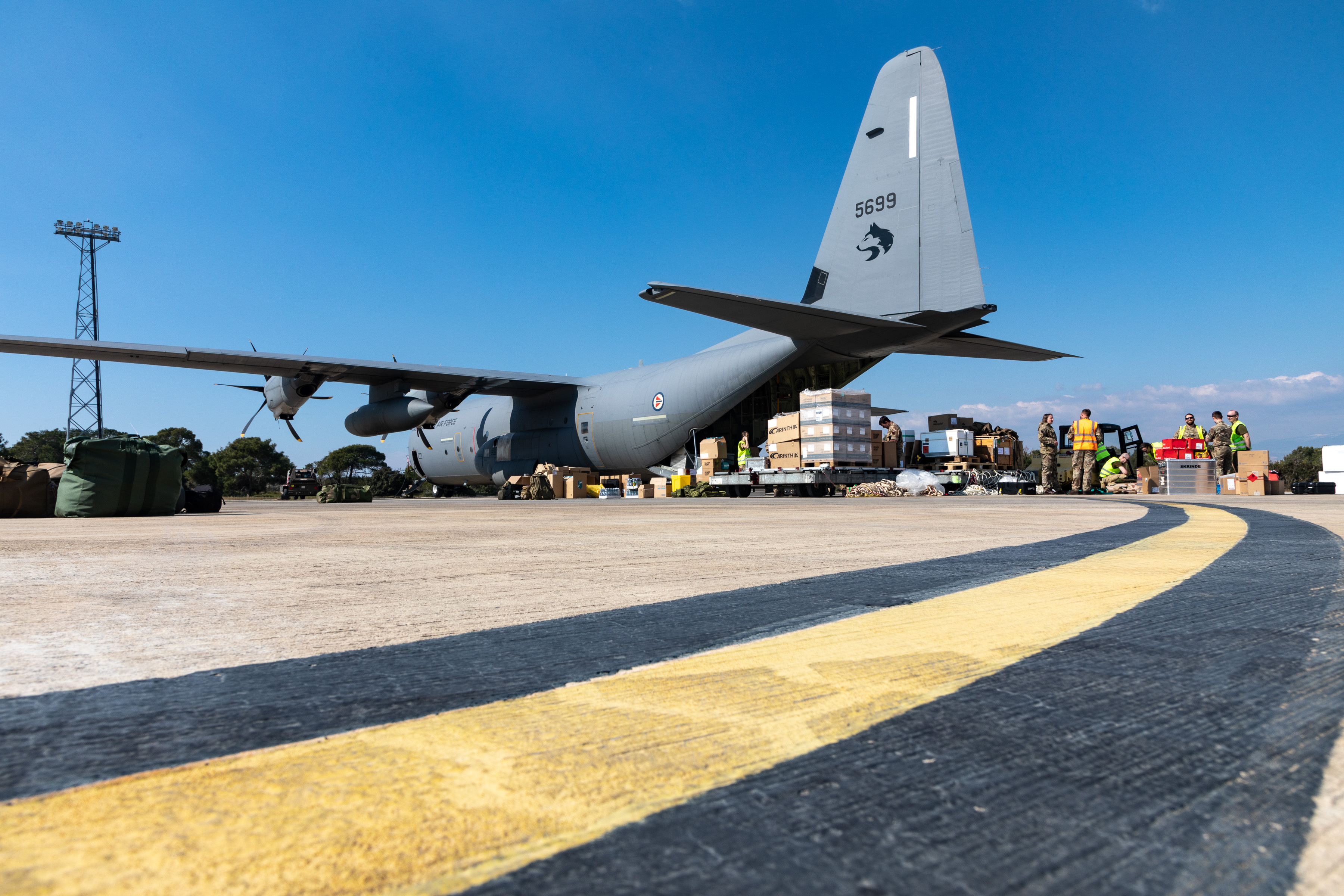 Image shows RAF Hercules aircraft on the airfield.